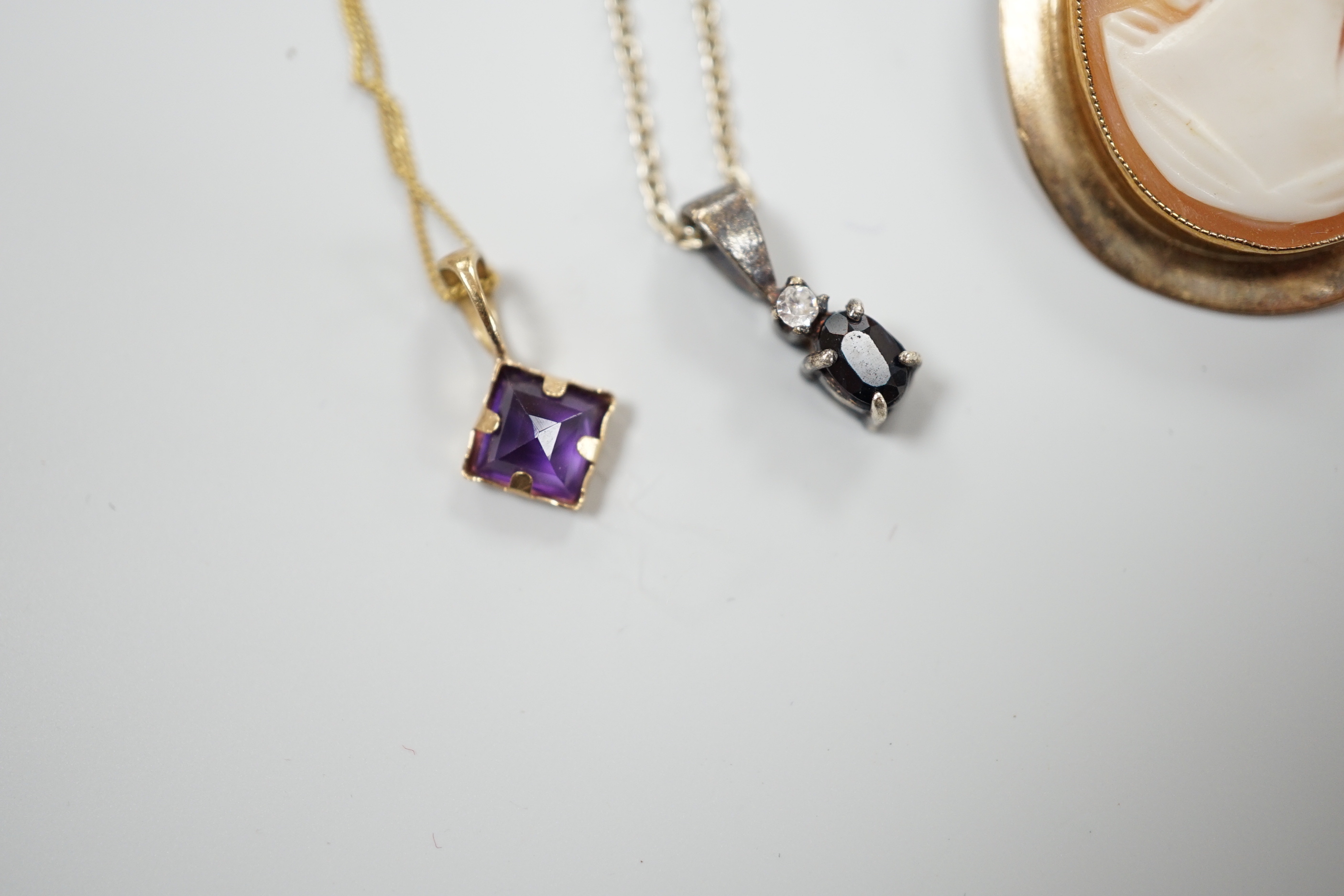 A modern 9ct gold mounted oval cameo shell brooch and two pendant necklaces including one 9ct.